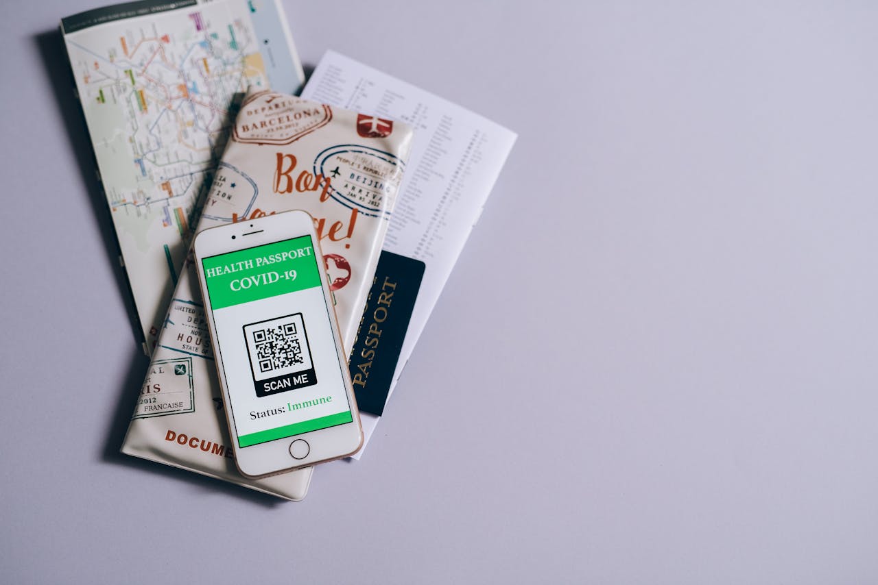 services-01 A health passport for COVID-19 displayed on a smartphone alongside travel documents.